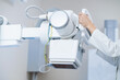 female doctor works with an x-ray machine in a modern hospital. Medical equipment operator closeup hands in clinic	