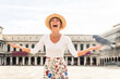 Happy beautiful woman travelling in Venice, Italy - Portrait of authentic adult female sighseeing venetian landmarks and having fun
