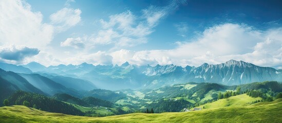 Sticker - Green valley with distant mountains under cloudy sky