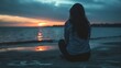 © Ameli Studio - Young woman sitting beach sunset sea sand mental health thinking looking