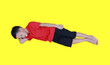 Sleeping Asian boy with arm support his head isolated on yellow background. Full length.