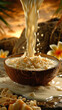 A bowl of coconut milk is poured into a bowl of coconut flakes