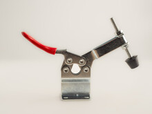 Single Metal Toggle Clamp Red Lever, Black Rubber Foot Isolated On A White Background