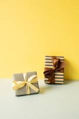 Wall Mural - Gift boxes on gray table. yellow wall background