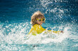 Kid enjoying summer holiday, swiming in pool. Kid having fun on summer holidays at pool. Happy kids playing on pool water. Happy Summer. Child on summer vacations play in the water.