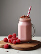A  glass jar full of  creamy raspberry banana smoothie with cacao powder
