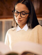 College student, studying and girl with textbook in home for university, research or school education. Learning course, glasses and Indian woman reading novel for academic information or knowledge