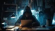A hacker in a dark room wearing a hoodie is sitting at a desk looking at a laptop.