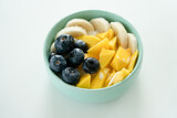 Fototapeta Mapy - Blueberries, mango and banana in bowl