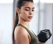 Woman, fitness and dumbbell in gym for power, exercise and training for strong arm muscle. Female person, bodybuilder and athlete for sport and health, club and equipment for workout or weightlifting