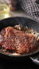 Wall Mural - A chef cooks a beef steak on a pan in the kitchen and turns it to the other side, close-up. Process of making delicious steak.