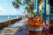 Glass of Cuban rum with ice on a wooden table, the ocean embankment is visible in the distance