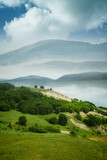 Fototapeta Natura - summer landscape with green meadow and hills
