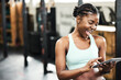 © peopleimages.com - Gym, healthy and black girl with tablet, happy and videos for fitness, practice and sports online. Club, app and technology for person, internet and wellness with sportswear, training and weekend