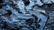 Black oil spill, environmental disaster, industrial pollution. A close-up view of a viscous black oil spill, showcasing the texture and sheen