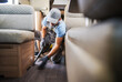 Worker Vacuuming and Cleaning Rental RV Motor Home