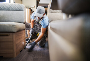 Wall Mural - Worker Vacuuming and Cleaning Rental RV Motor Home