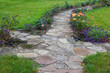 stone paved garden path and flowers - roses and lavender