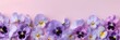 Soft pastel pink background highlighting a delicate pattern of purple and pink pansies, a symbol of remembrance