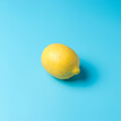 Fresh lemon on blue background. Minimal food concept.