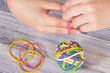 Preschooler hands playing with rubber bands or erasers. Development of kids motor skills, coordination logical thinking