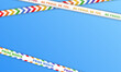 Empty banner and white barricade tapes with rainbow LGBT flag diagonal stripes for Pride Month on blue background. Template of wallpaper with seamless LGBTQ+ ribbons, stripes and copy space for text