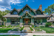 A front view of a striking emerald green craftsman cottage style home, with a triple pitched roof, expertly designed landscaping,