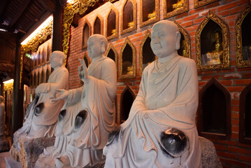 Wall Mural - Many Buddha statues in a hindu temple in Vietnam