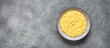 Mashed potatoes in a bowl on a gray concrete background, banner. Top view, flat lay, copy space