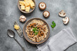 Risotto with mushrooms on a gray concrete background. Top view, flat lay. Risotto with brown mushrooms and ingredients.