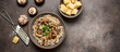 Risotto with mushrooms on a dark rustic background. Traditional Italian dish. Top view, flat lay, banner.