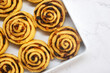 Uncooked mixed fruit cinnamon rolls dough on a baking tray in preparation for baking