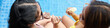 © DragonImages - Web banner with mother and daughter eating ice cream at swimming pool