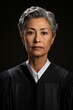 b'Portrait of a serious looking female judge in her robes'