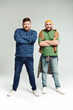 © Bliss - Two men with crossed arms stand confidently next to each other.