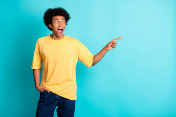 Canvas Print - Photo of astonished guy with afro hairdo dressed yellow t-shirt look directing at promo empty space isolated on turquoise color background