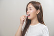 Flossing teeth, dental care hygiene, asian young woman flossing teeth with dental floss pick, smile happy with perfect white teeth, using tooth floss cleaning, healthy teeth isolated on background.