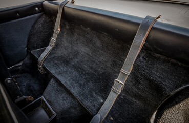 Canvas Print - Leather luggage straps in a car