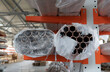 metal pipes in white packaging film on a cantilever rack 