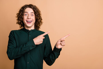 Poster - Photo of cheerful joyful nice man wear trendy green clothes demonstrate poster news empty space isolated on beige color background