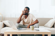 © SHOTPRIME STUDIO - Tired African American Man Working on Laptop in Home Office Depressed Freelancer Experiencing Crisis and Unhappiness, Sitting on Sofa