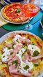 Pizza Mortadella served with an Aperol spritz in typical Italian restaurant near Como Lake, Lombardy, Italy, Europe. Classic dish from Italy. Eating lunch in local restaurant in city center of Como