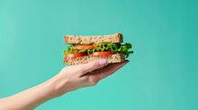 Ad Shot Of A Hand With A Gourmet Sandwich, Pastel Cyan Background, Minimalist, Studio Lighting,