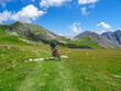 Front view of sports man on scenic mtb trail near rifugio della Gardetta on Italy French border in Maira valley in the Cottian Alps, Piedmont, Italy, Europe. Biking on sunny summer day in mountains
