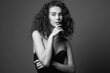 beautiful young woman with curly hair. black and white portrait