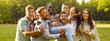 Group of happy, diverse, multiracial friends having fun in a green sunny summer park. Several cheerful, joyful people carrying young African American woman all together. Banner. Friendship concept