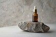 A bottle of essential oil sitting on a rock, perfect for aromatherapy concept