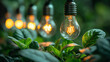 Electric lamps hangs above the green plants in greenhouse, background with copy space