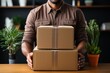 Delivery man holding cardboard boxes in office setting