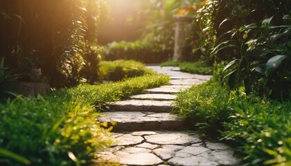 Stone walkway in the green garden with sun light